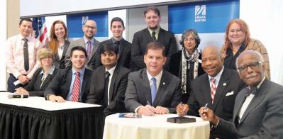 Mayor Walsh and UMass Boston Chancellor Keith Motley signed an agreement last Friday that will continue the university’s new Mayor’s Policy Symposium into future years. That same day, the inaugural class briefed the mayor on its ideas for revitalizing the Strand Theatre. 	Harry Brett/UMB photo